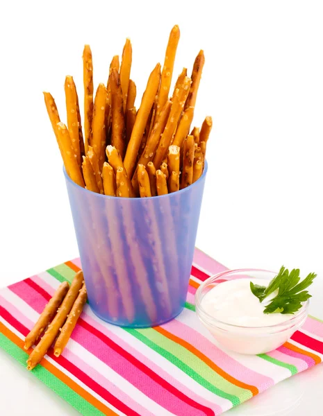 Tasty crispy sticks in purple plastic cup isolated on white — Stock Photo, Image