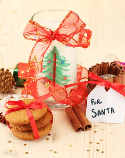 Cookies for Santa: Conceptual image of ginger cookies, milk and christmas decoration on light background — Stock Photo, Image