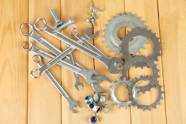 Machine gear, metal cogwheels, nuts and bolts on wooden background — Stock Photo, Image