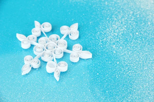 Beautiful paper snowflake, on blue background — Stock Photo, Image