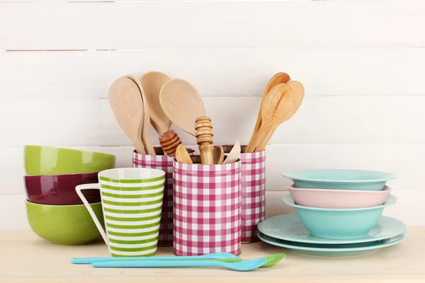 Cups, bowls nd other utensils in metal containers isolated on light background — Stok fotoğraf