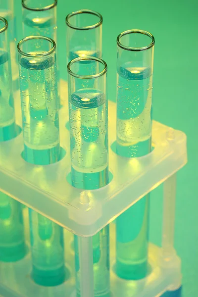 Test-tubes with liquid on blue background — Stock Photo, Image