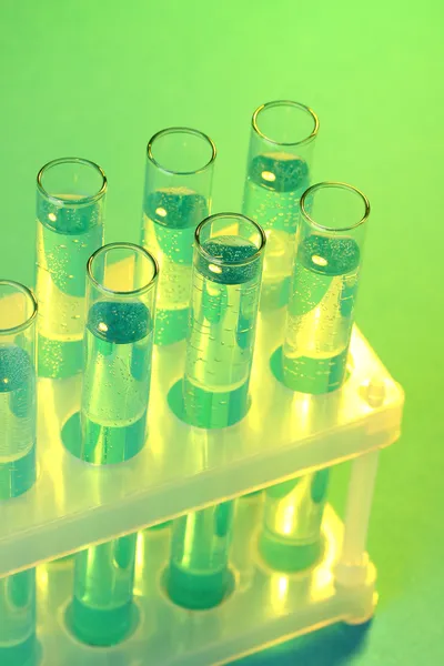 Test-tubes with liquid on blue background — Stock Photo, Image