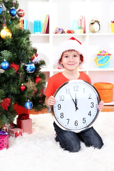 Little boy with clock in anticipation of New Year Royalty Free Stock Images