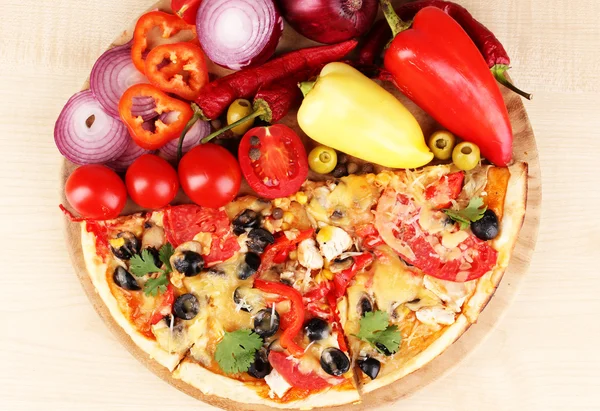 Delicious pizza with ingredients close-up on wooden table background — Stock Photo, Image