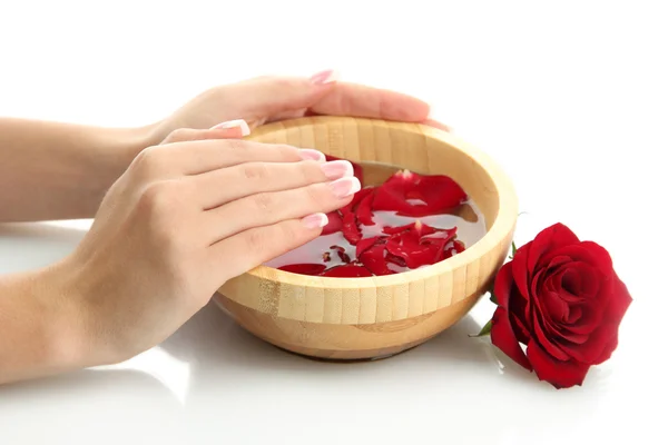 Woman hands with wooden bowl of water with petals, isolated on white — Stock Photo, Image