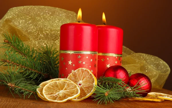 Two candles and christmas decorations, on wooden background — Stock Photo, Image