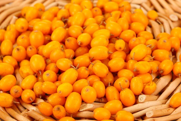 Sea buckthorn on wicker mat close-up — Stock Photo, Image