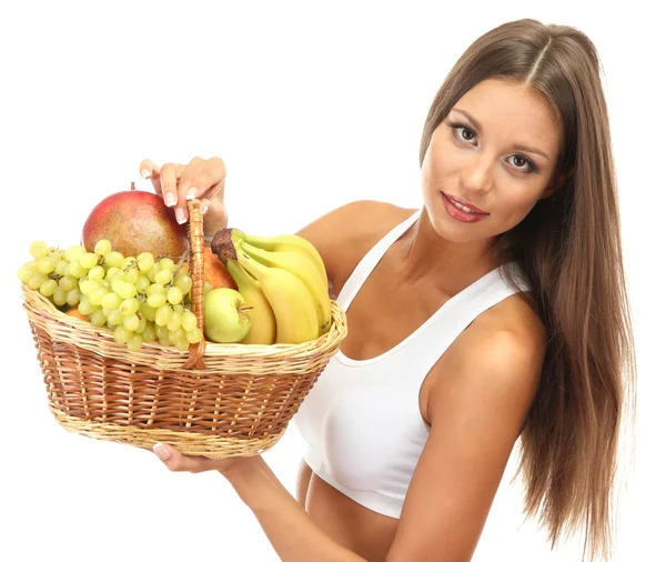 Beautiful young woman with fruits in basket, isolated on white — Stock Photo, Image