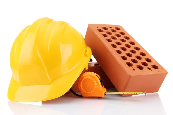 Helmet, roulette and bricks isolated on white — Stock Photo, Image