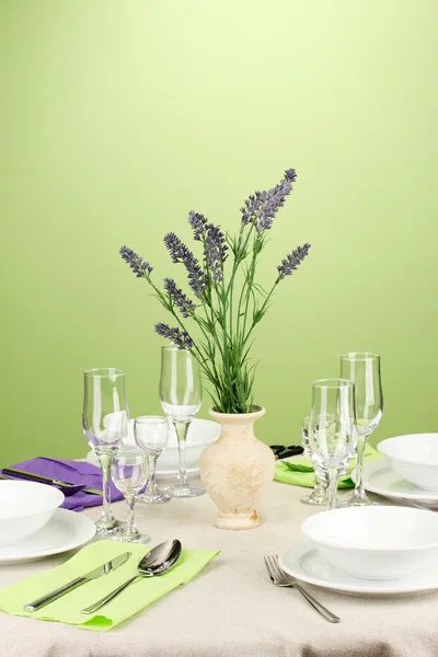 Table setting in violet and green tones on color background — Stock Photo, Image