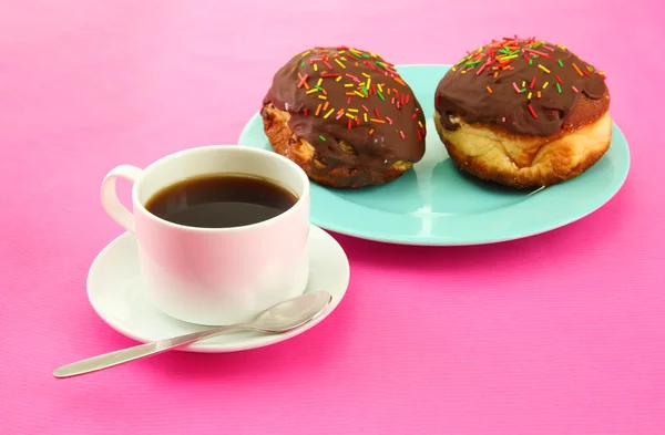 Tasty donuts on color plate on color background — Stock Photo, Image