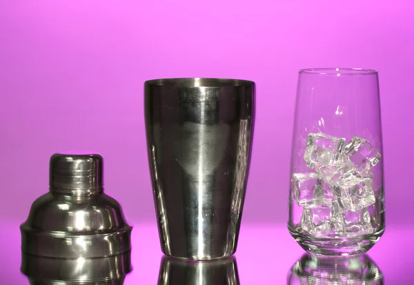 Cocktail shaker e coquetel de vidro sobre fundo de cor — Fotografia de Stock