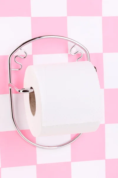 Roll of toilet paper on holder fixed to wall in bathroom — Stock Photo, Image