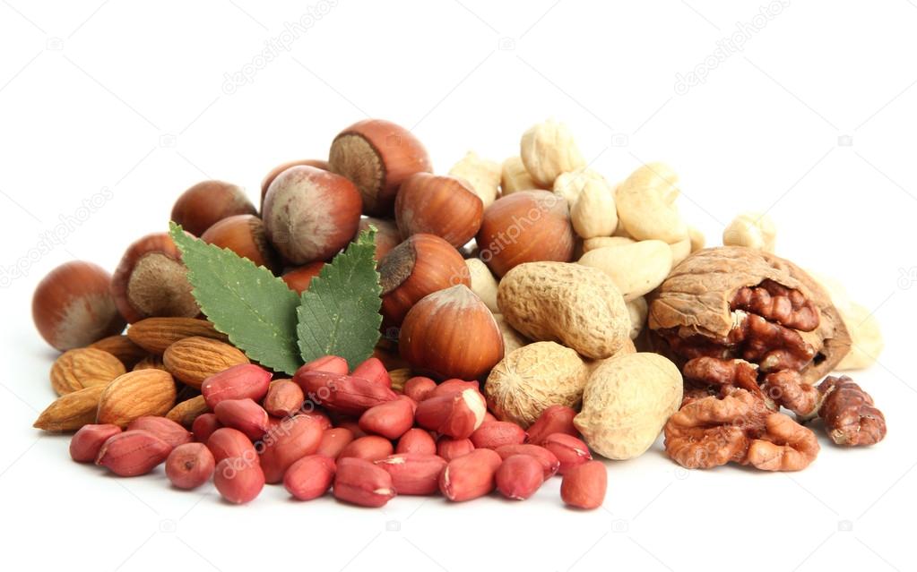 assortment of tasty nuts with leaves, isolated on white