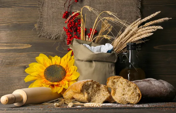 Rye bread on wooden table on wooden background — Stock Photo, Image