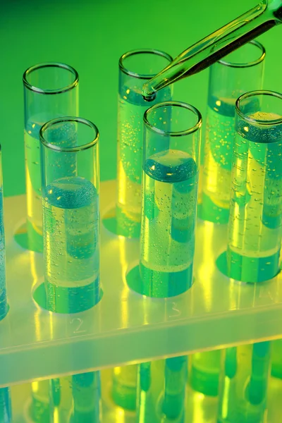 Test-tubes with liquid on blue background — Stock Photo, Image