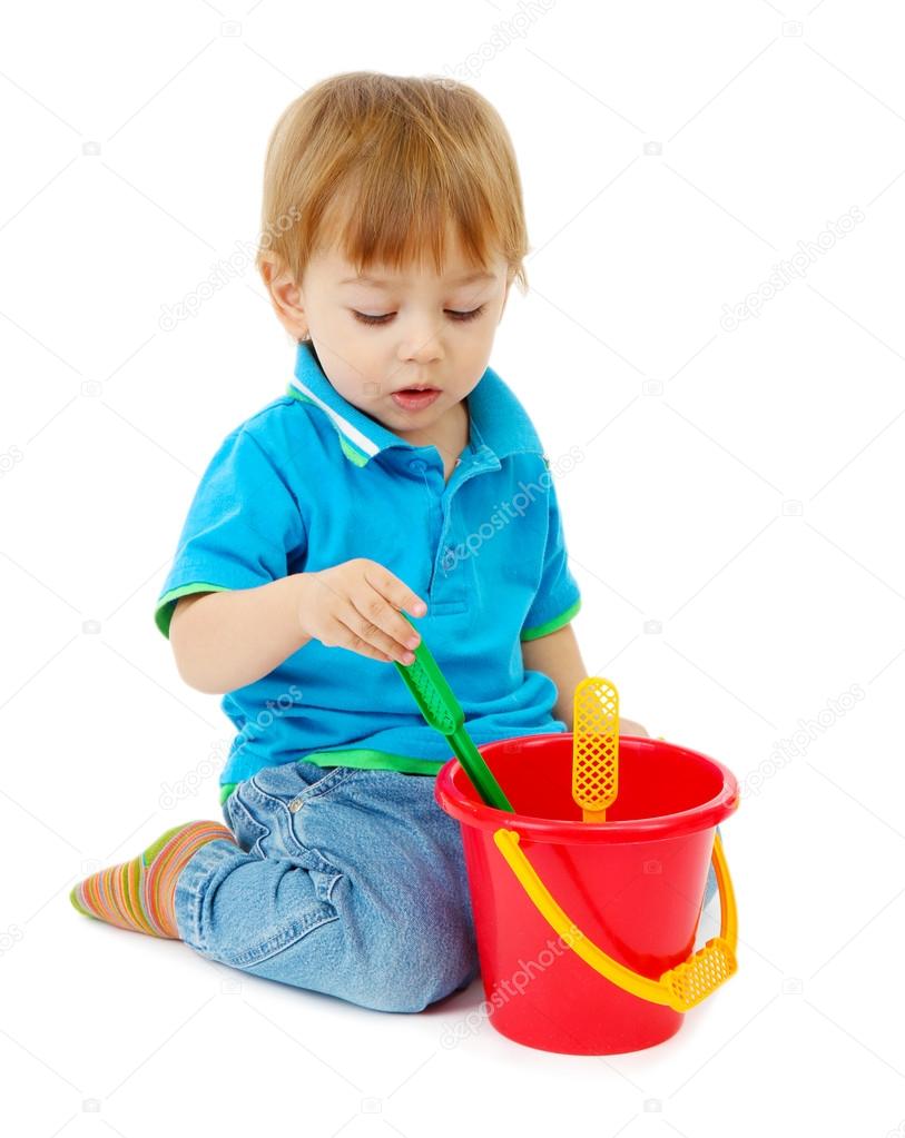 cute little boy with toy bucket, isolated on white