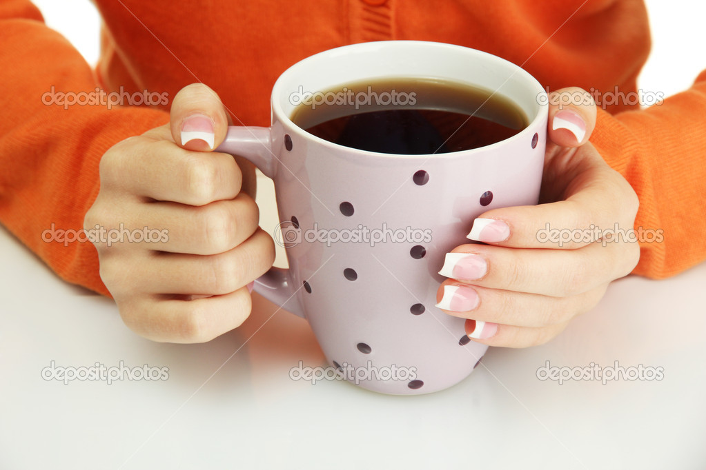 hands holding mug of hot drink, close-up