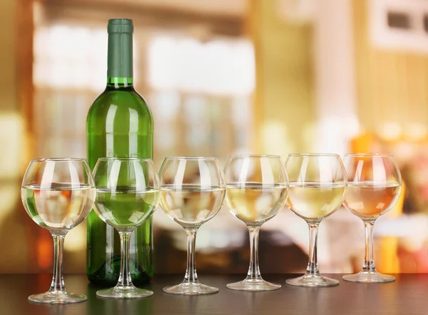 White wine in glass and bottle on room background — Stock Photo, Image