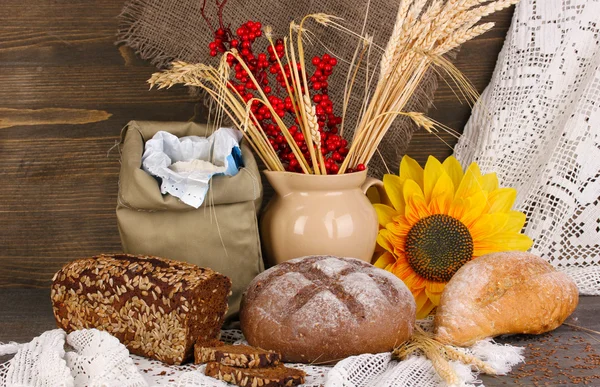 Different types of rye bread on wooden table on autumn composition background — Stock Photo, Image