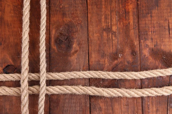 Frame composed of rope on wooden background — Stock Photo, Image