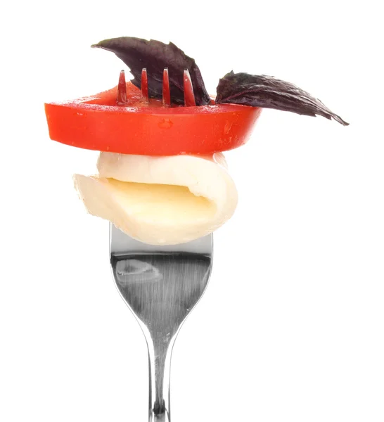 Tasty mozzarella with tomatoes on fork isolated on white — Stock Photo, Image