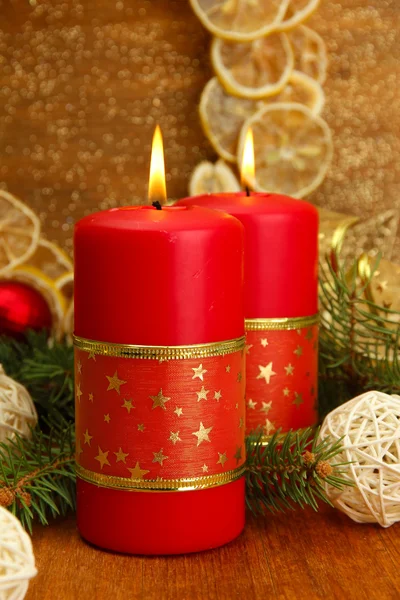 Zwei Kerzen und Weihnachtsdekoration, auf goldenem Hintergrund — Stockfoto