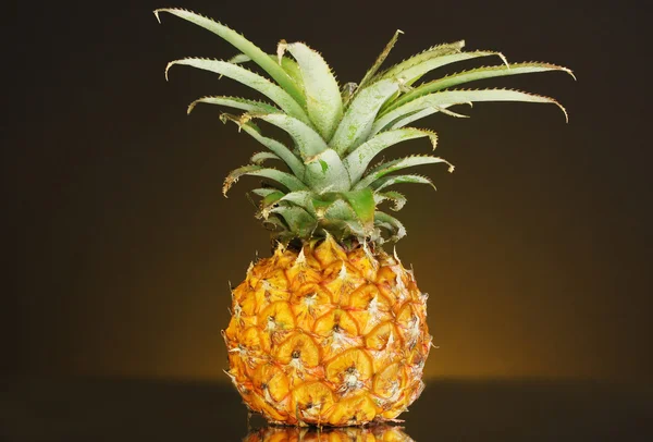 Ripe pineapple on dark yellow background — Stock Photo, Image