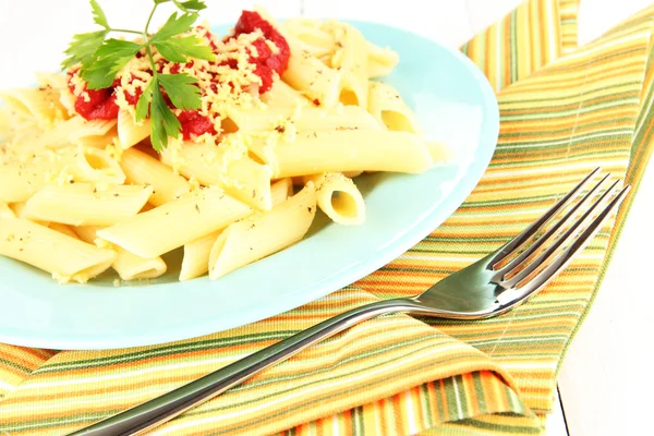 Plato de pasta Rigatoni con salsa de tomate sobre mesa de madera blanca de cerca —  Fotos de Stock