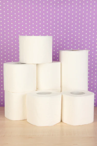 Rolls of toilet paper on purple with dots background — Stockfoto