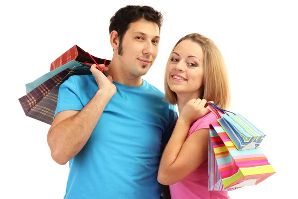 Joven pareja de compras y la celebración de muchas bolsas de compras aisladas en blanco — Foto de Stock