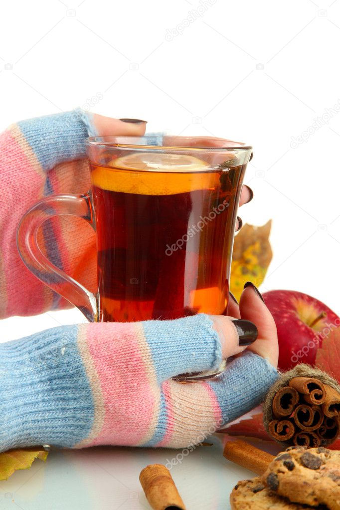 hands holding cup of hot drink and autumn leaves, isolated on white