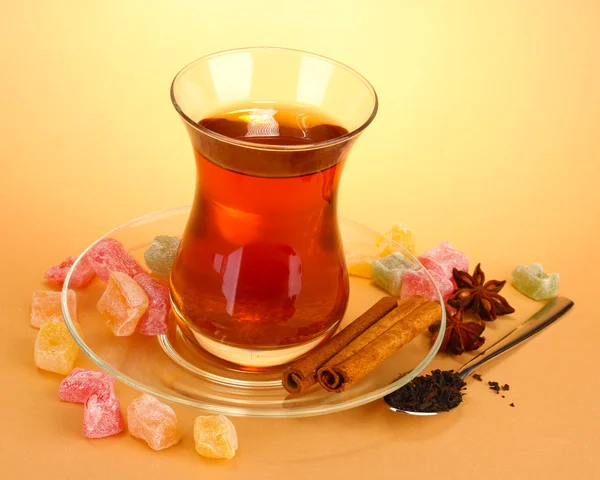 Glass of Turkish tea and rahat Delight, on beige background — Stock Photo, Image