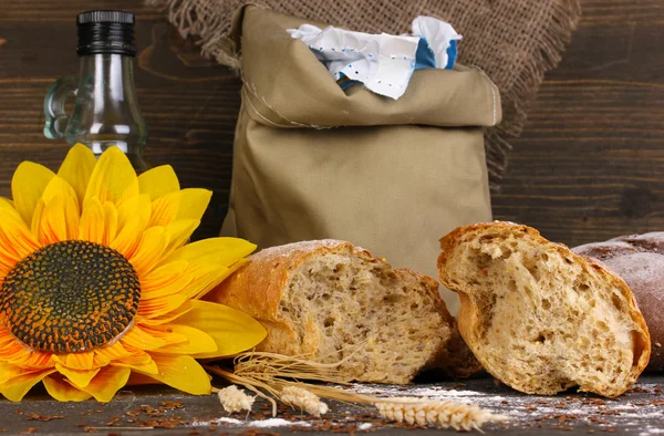 Rye bread on wooden table on wooden background — Stock Photo, Image