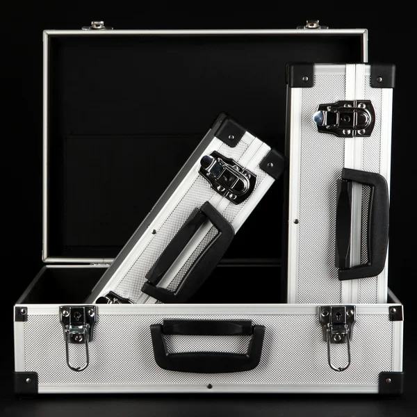 Silvery suitcases on black background — Stock Photo, Image