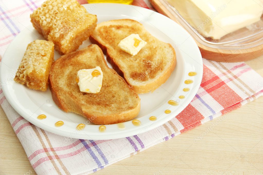white bread toastwith honey on plate in cafe