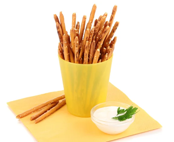 Tasty crispy sticks in yellow plastic cup isolated on white — Stock Photo, Image