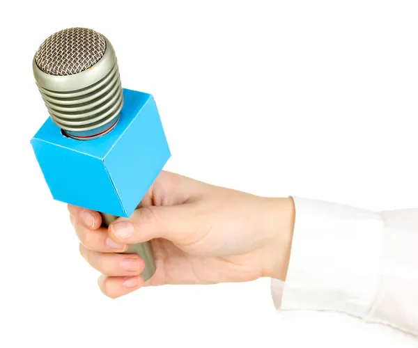 Mano femminile con microfono isolato su bianco — Foto Stock