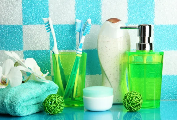 Bath accessories on shelf in bathroom on blue tile wall background — Stock Photo, Image