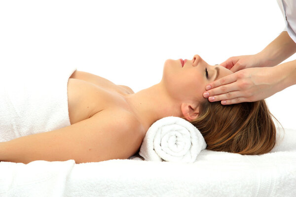 Portrait of beautiful woman taking head massage, isolated on white