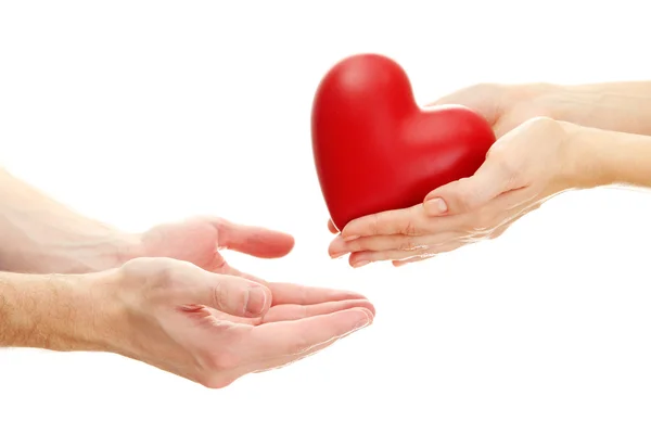 Nő és férfi kezében, elszigetelt fehér piros szív — Stock Fotó