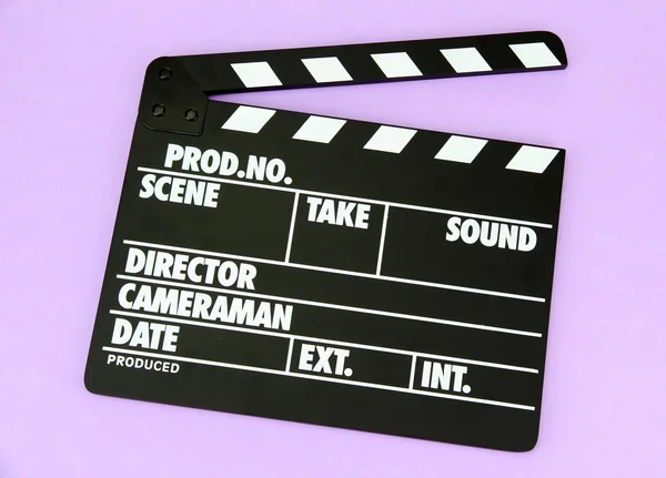 Movie production clapper board on color background — Stock Photo, Image