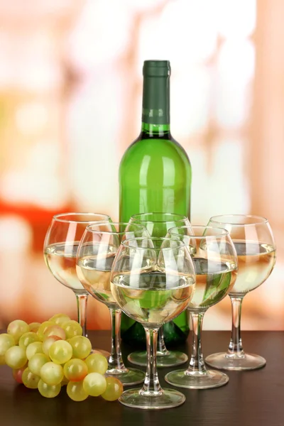 White wine in glass and bottle on room background — Stock Photo, Image