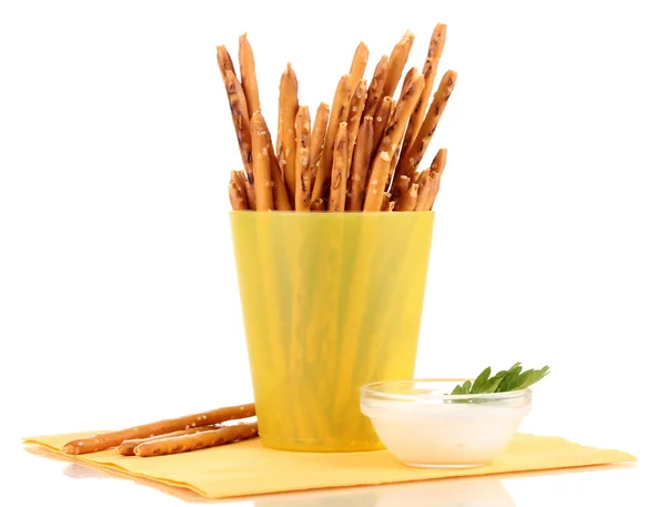 Tasty crispy sticks in yellow plastic cup isolated on white — Stock Photo, Image