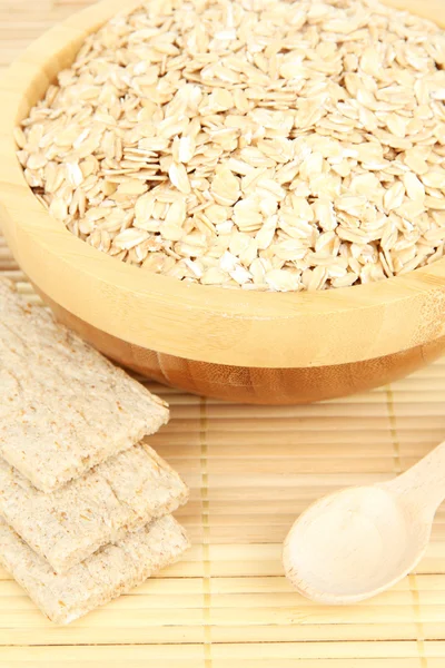 Wooden bowl full of oat flakes — Stock Photo, Image