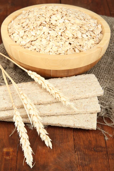 Oat flakes in wooden bowl on the table — Stock Photo, Image