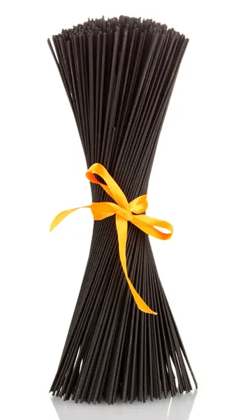 Black spaghetti with ribbon isolated on white — Stock Photo, Image