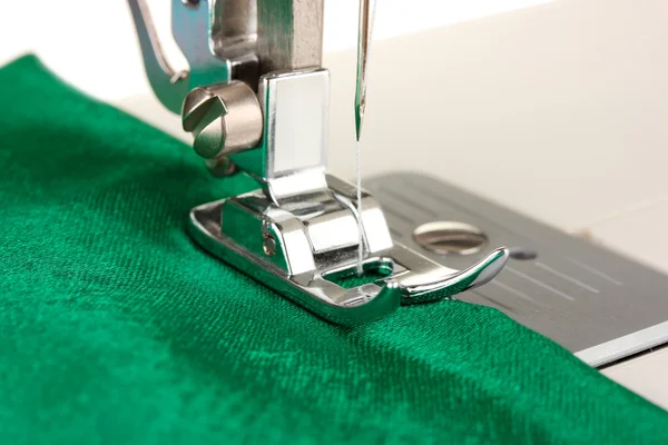 Closeup of sewing machine working part with green cloth — Stock Photo, Image