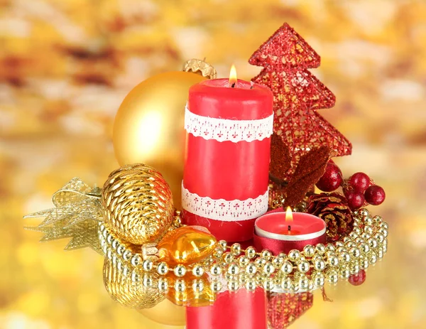 Red candle with christmas decoration on bright background — Stock Photo, Image